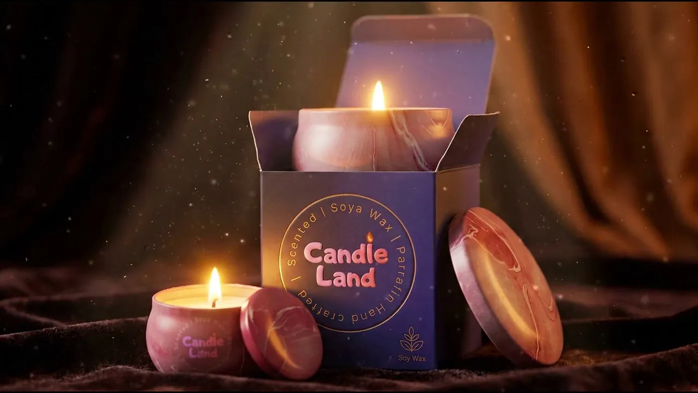 A lit Candle Land candle glowing against soft draped fabric